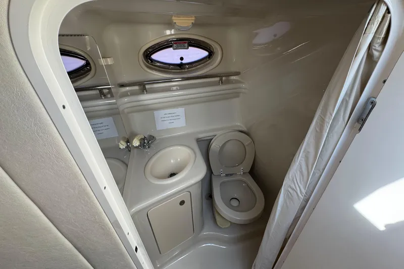Slide: The Image of Compact bathroom in 2006 Sea Ray Sundancer 260 boat, featuring toilet and sink. - 29