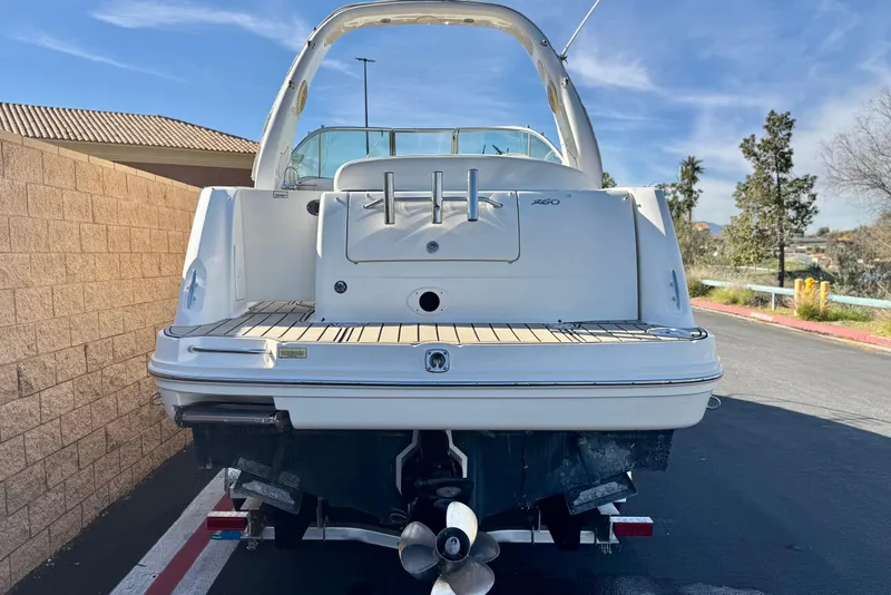 Slide: The Image of 2006 Sea Ray Sundancer 260 boat, rear view, parked outdoors on a sunny day. - 3