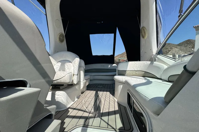 Slide: The Image of Interior of 2006 Sea Ray Sundancer 260 boat with white seating and open canopy. - 31