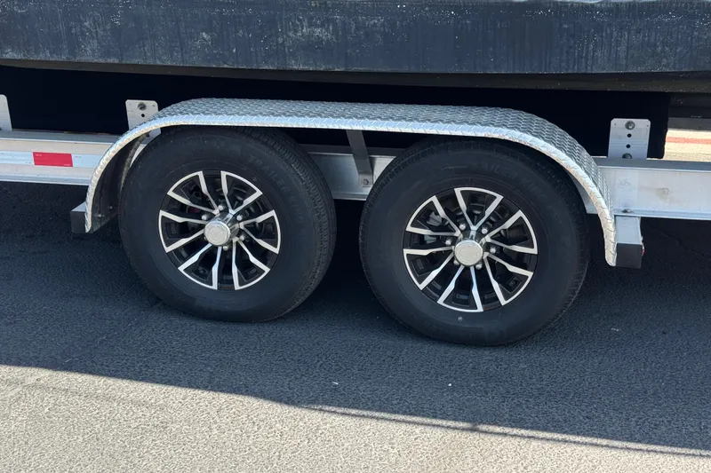 Slide: The Image of Trailer wheels for 2006 Sea Ray Sundancer 260 boat on asphalt surface. - 32