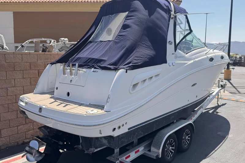 Slide: The Image of 2006 Sea Ray Sundancer 260 boat on trailer, covered with navy blue canvas. - 5