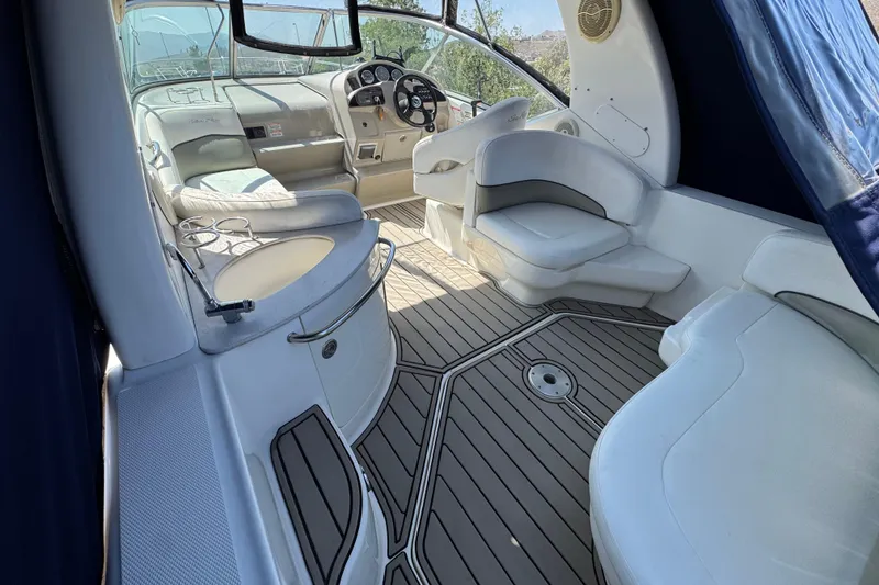 Slide: The Image of Interior of 2006 Sea Ray Sundancer 260 boat with white seating and wood flooring. - 9