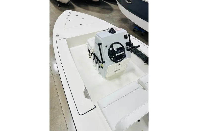Slide: The Image of 2026 Hewes Redfisher 18 boat interior with steering console and seating. - 4