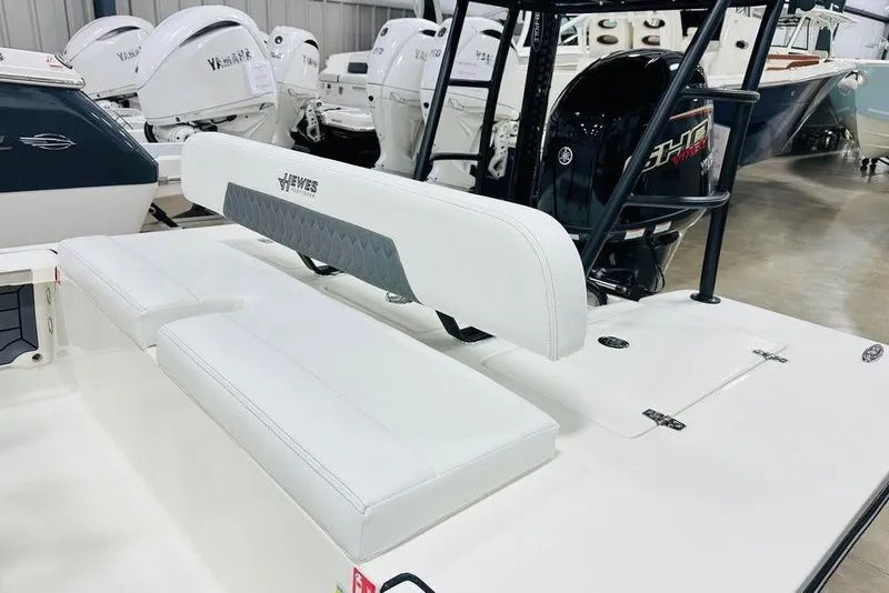 Slide: The Image of 2026 Hewes Redfisher 18 boat interior with white seating and Yamaha outboard motor. - 6