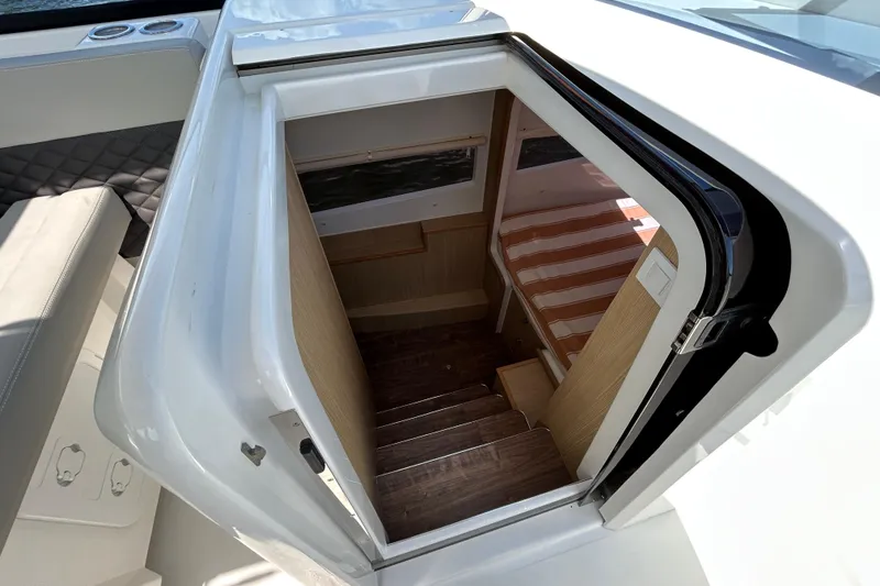 Slide: The Image of Interior view of 2020 Aquila 36 Sport boat cabin entrance with wooden stairs. - 14