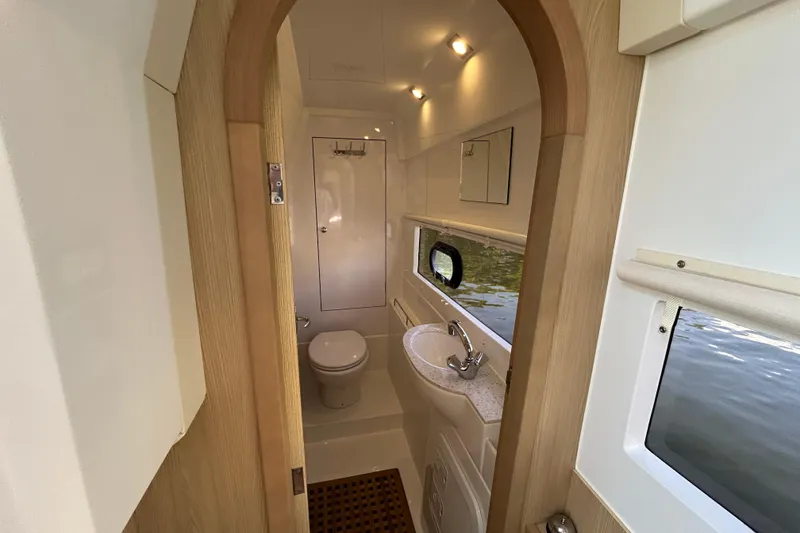 Slide: The Image of Bathroom interior of 2020 Aquila 36 Sport yacht, featuring modern fixtures and window view. - 17