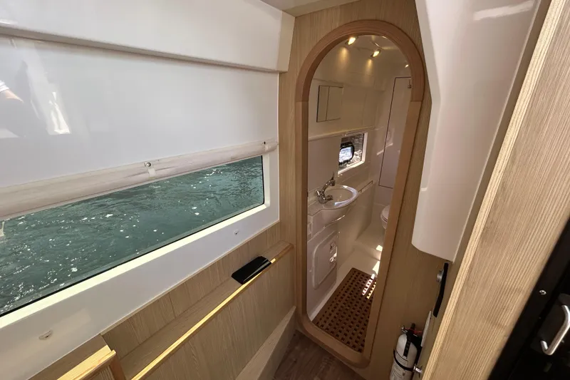 Slide: The Image of Interior of 2020 Aquila 36 Sport yacht, featuring a modern bathroom and window view. - 20