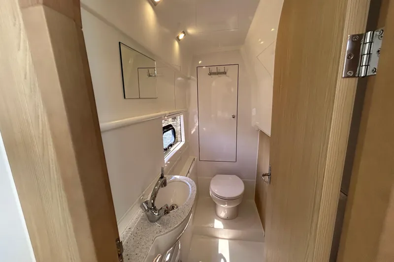 Slide: The Image of Modern bathroom interior of 2020 Aquila 36 Sport yacht, featuring sink, toilet, and mirror. - 21
