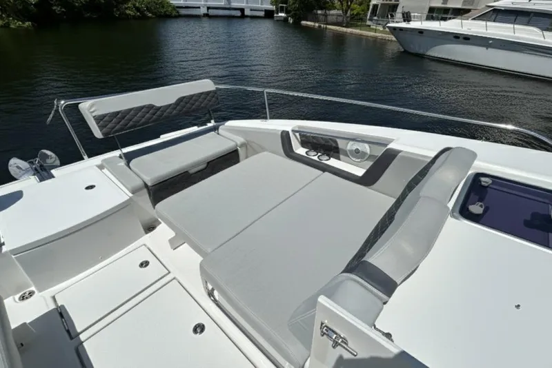 Slide: The Image of Aquila 36 Sport 2020 boat interior with cushioned seating and water view. - 24