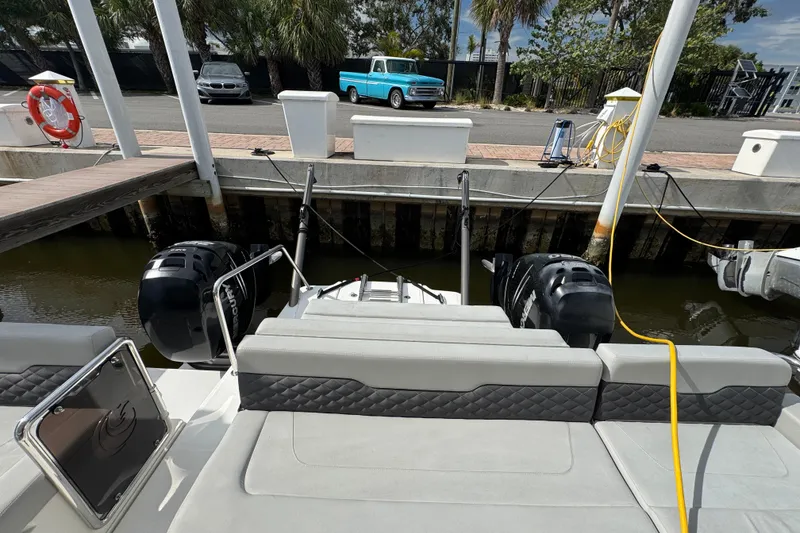 Slide: The Image of Aquila 36 Sport 2020 docked, featuring dual outboard engines and a spacious seating area. - 27