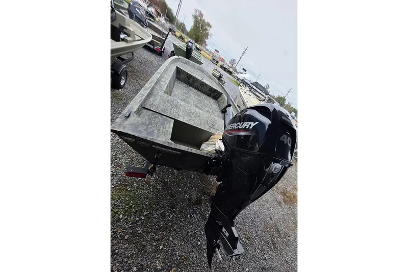 Slide: The Image of 2026 Tracker Grizzly 1754 Utility boat with Mercury 40 outboard motor on gravel. - 3