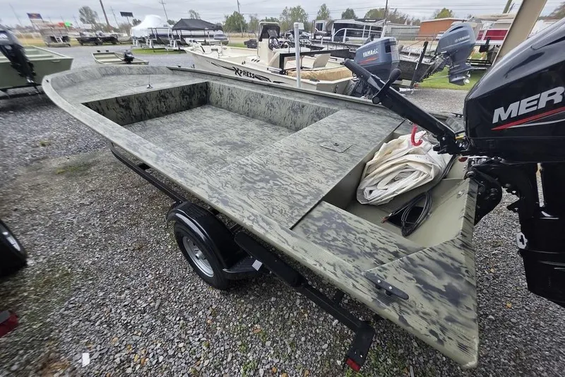 Slide: The Image of 2026 Tracker Grizzly 1754 Utility boat with camouflage design and Mercury outboard motor. - 7