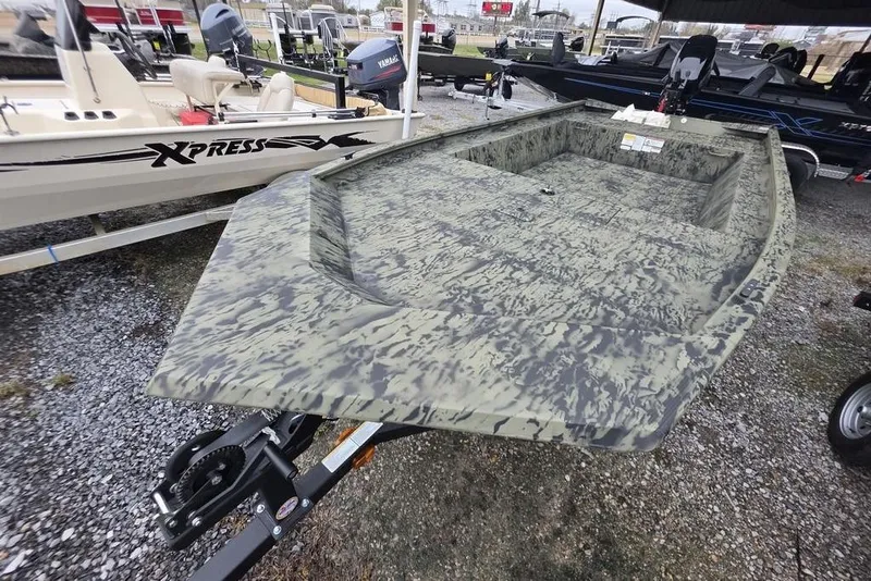 Slide: The Image of 2026 Tracker Grizzly 1754 Utility boat with camouflage design on display outdoors. - 8