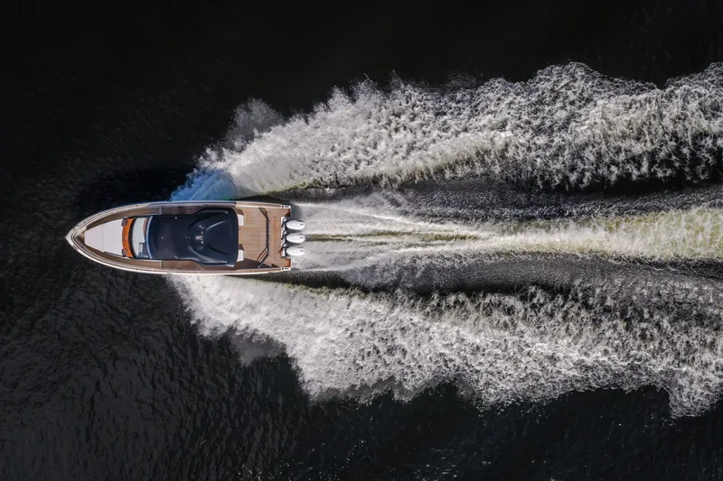 Slide: The Image of Aerial view of 2025 Invictus TT430 yacht speeding on water, creating dynamic wake patterns. - 105