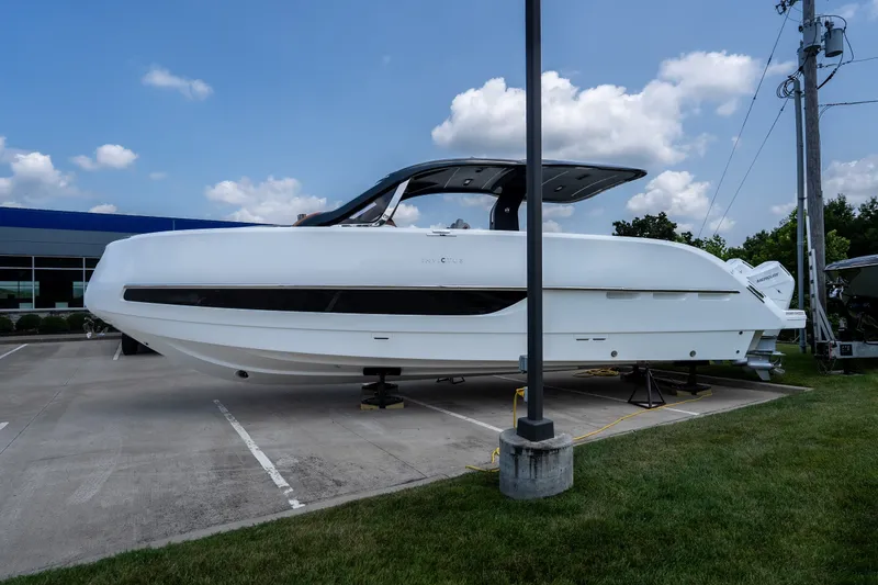 Slide: The Image of 2025 Invictus TT430 yacht displayed outdoors on a concrete platform under a blue sky. - 2