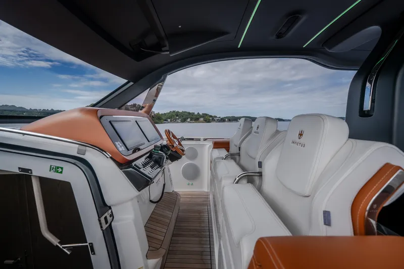 Slide: The Image of Interior of 2025 Invictus TT430 yacht with luxurious seating and modern dashboard. - 48