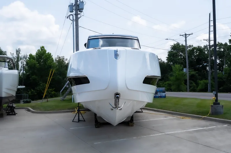 Slide: The Image of 2025 Invictus TT430 yacht on display in a parking lot, front view. - 7