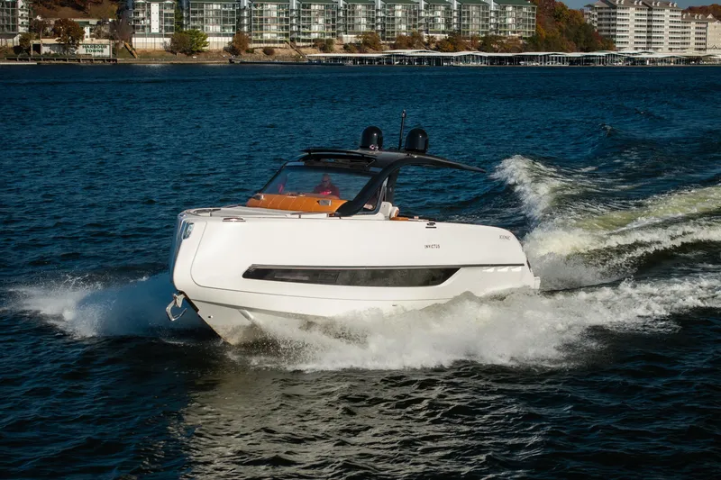 The Image of 2025 Invictus TT430 yacht cruising on a scenic waterfront. - 1