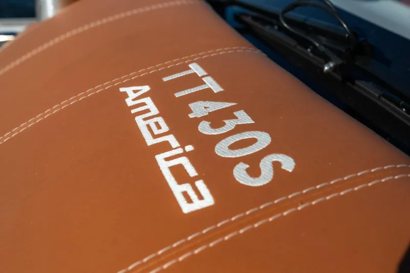 Slide: The Image of 2025 Invictus TT430S America logo on brown leather surface. - 10