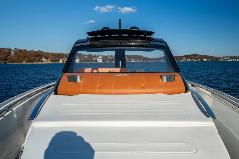 Slide: The Image of 2025 Invictus TT430 yacht on a serene lake with clear blue skies. - 11