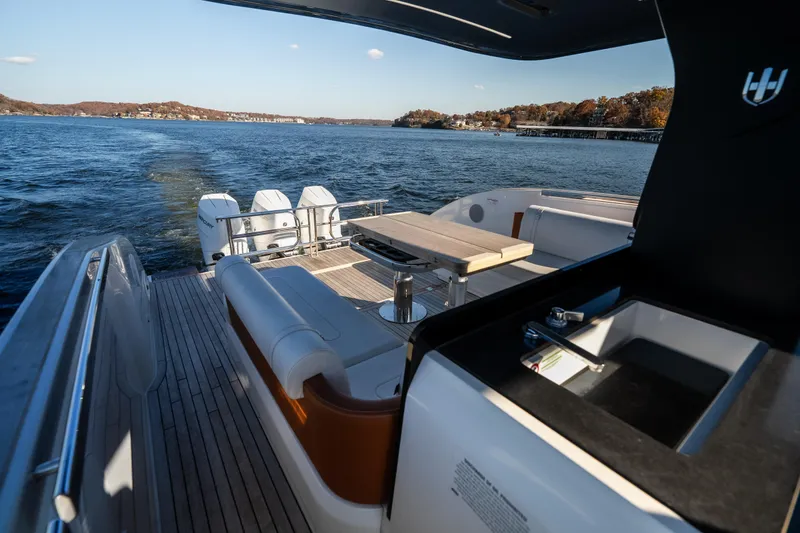 Slide: The Image of Luxurious 2025 Invictus TT430 yacht interior with seating and table on open water. - 16