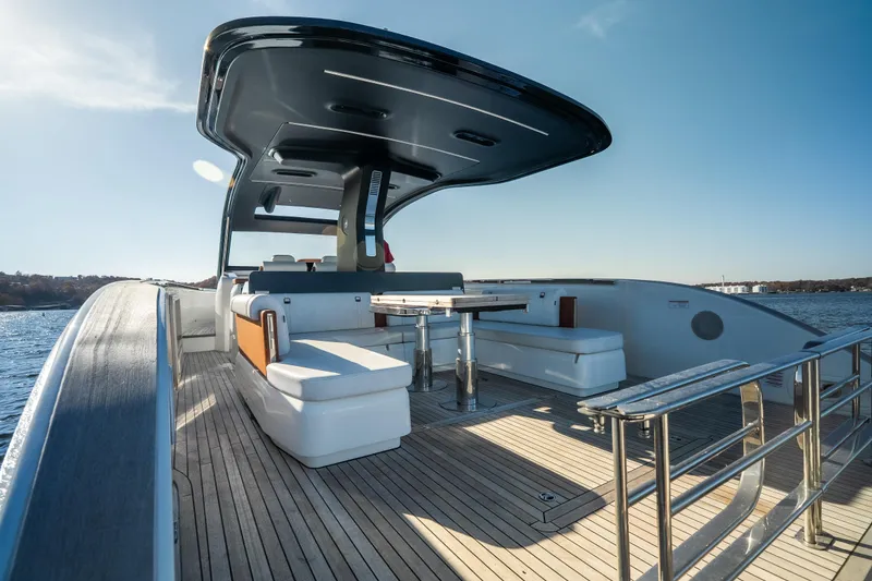 Slide: The Image of Luxurious 2025 Invictus TT430 yacht deck with seating and table, cruising on open water. - 19
