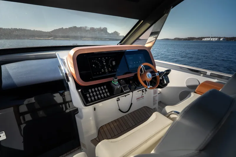 Slide: The Image of Modern helm of 2025 Invictus TT430 yacht with advanced navigation system and luxurious seating. - 20