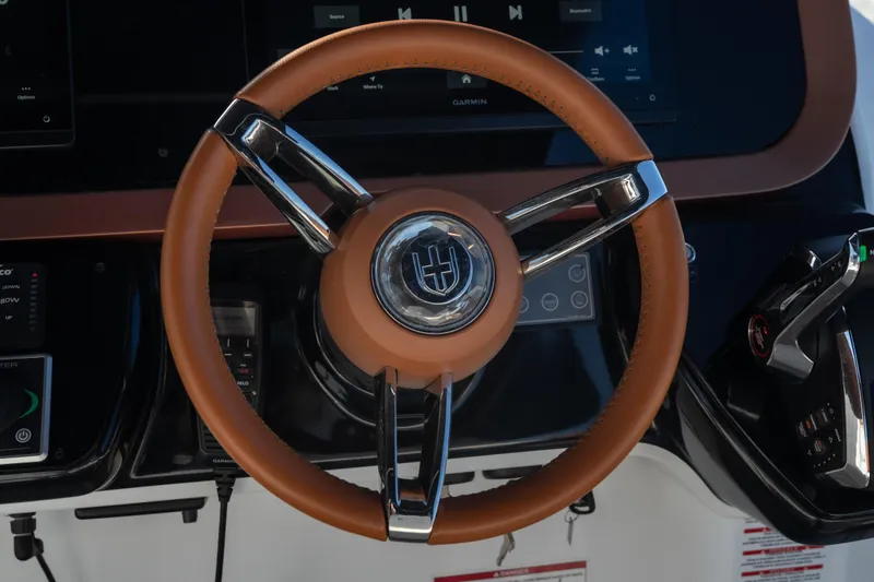 Slide: The Image of Steering wheel of 2025 Invictus TT430 boat with modern dashboard controls. - 22