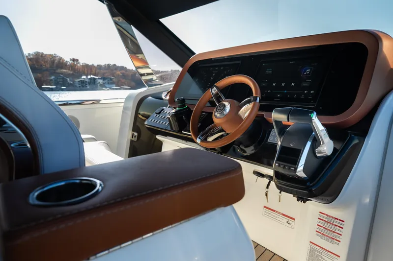 Slide: The Image of Luxurious 2025 Invictus TT430 yacht cockpit with modern steering and controls. - 24
