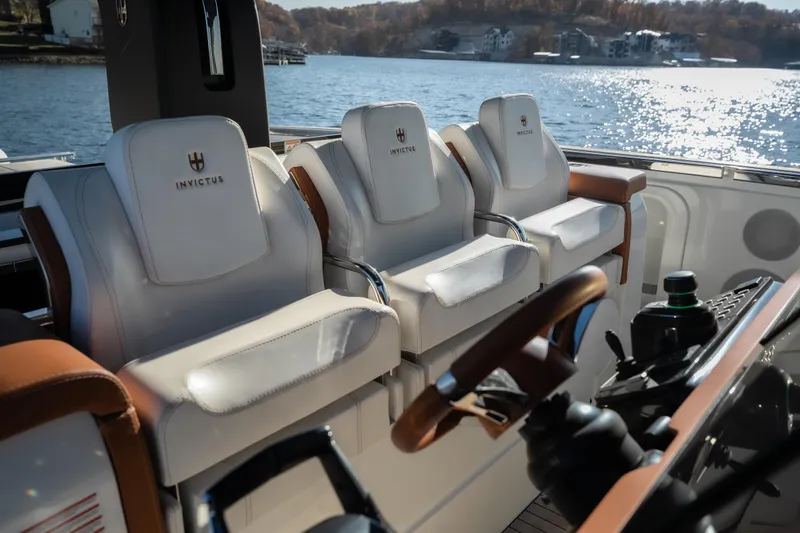 Slide: The Image of Luxurious Invictus TT430 yacht interior with plush seating, overlooking serene waters. - 25
