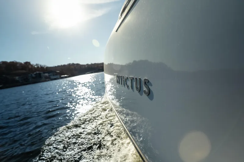 Slide: The Image of Invictus TT430 yacht cruising on sunny waters, 2025 model. - 28