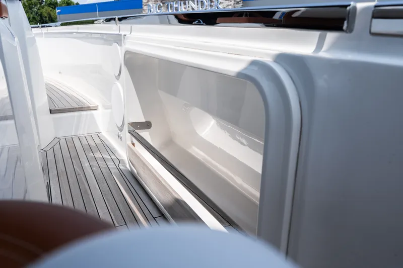 Slide: The Image of 2025 Invictus TT430 yacht interior with sleek white design and wooden flooring. - 24