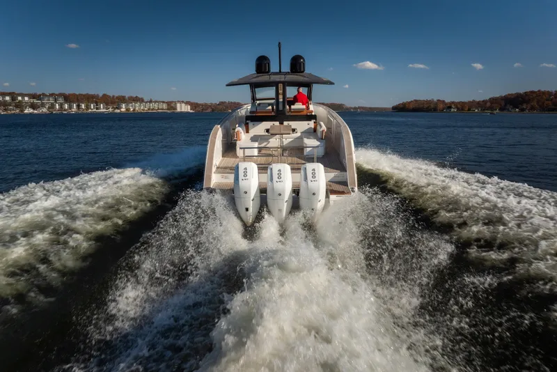 Slide: The Image of 2025 Invictus TT430 boat cruising on a lake with powerful engines. - 36