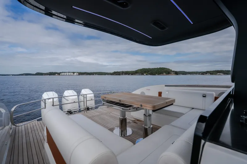 Slide: The Image of Luxurious 2025 Invictus TT430 yacht deck with seating, table, and scenic ocean view. - 40