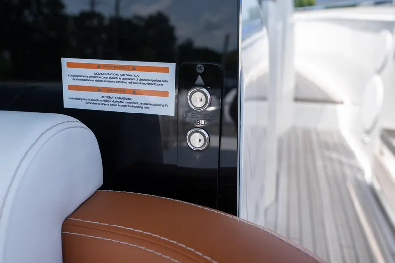 Slide: The Image of 2025 Invictus TT430 yacht interior with automatic handling warning label and control buttons. - 22