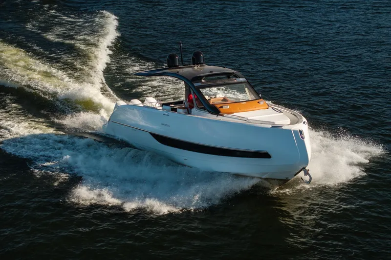 Slide: The Image of 2025 Invictus TT430 yacht cruising on open water, showcasing sleek design and powerful performance. - 4