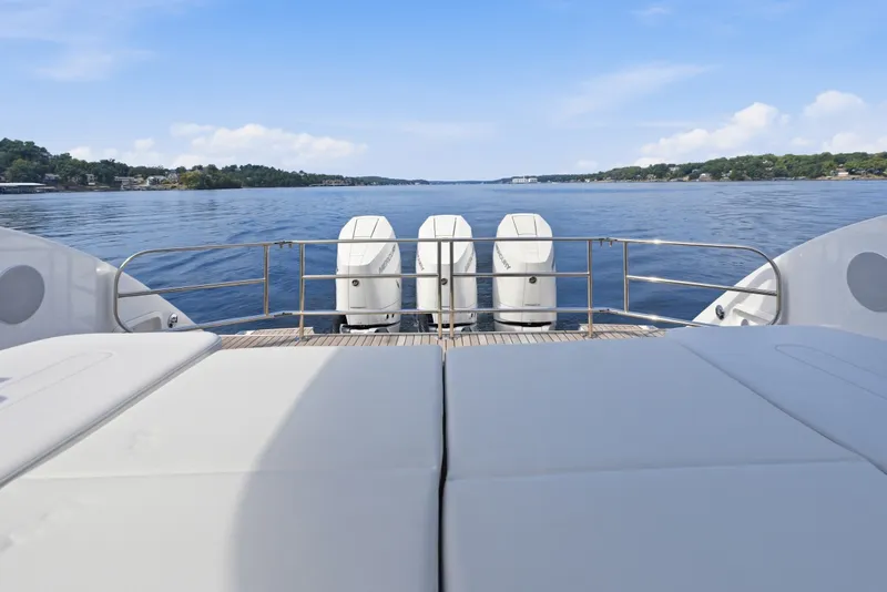 Slide: The Image of Invictus TT430 2025 yacht with triple engines on a serene lake backdrop. - 94