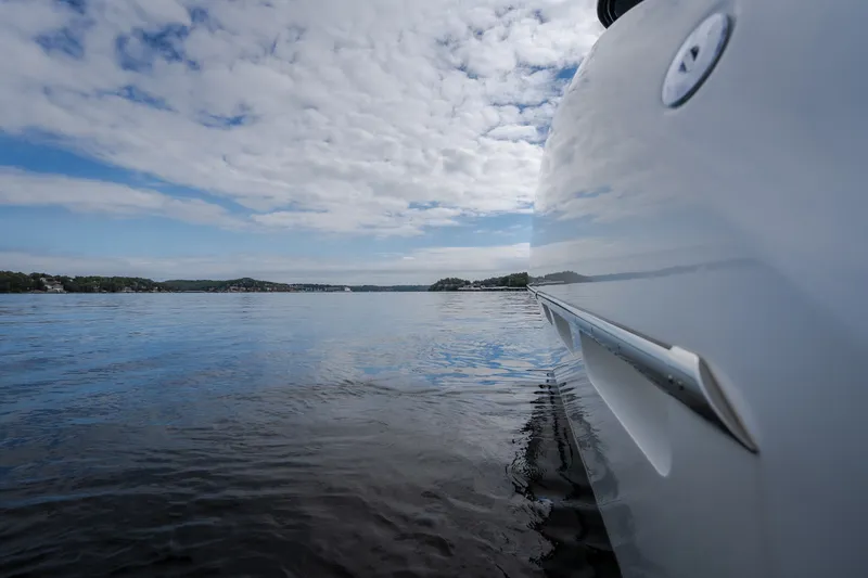 Slide: The Image of Invictus TT430 yacht on calm waters under a partly cloudy sky, 2025 model. - 34