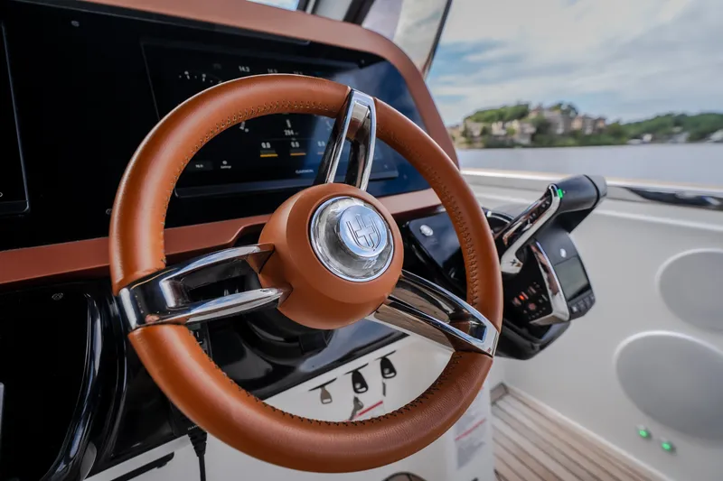 Slide: The Image of Luxurious steering wheel of 2025 Invictus TT430 yacht, featuring sleek design and advanced controls. - 54