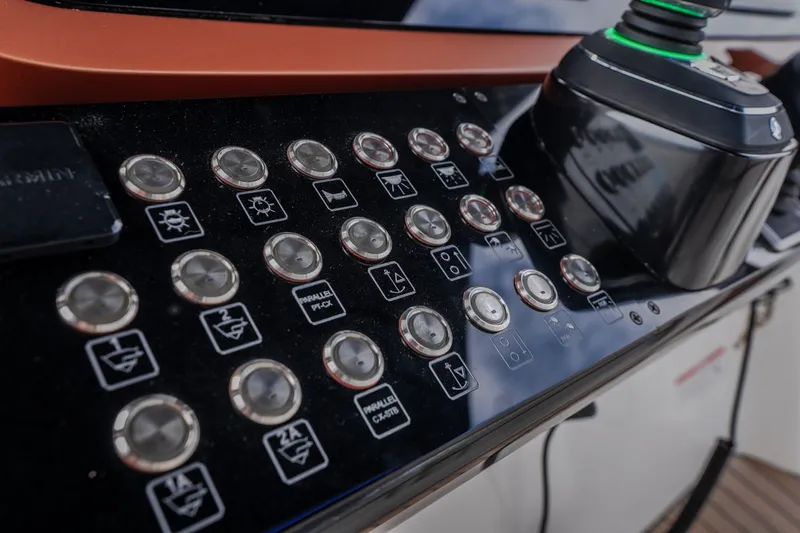 Slide: The Image of Control panel of 2025 Invictus TT430 yacht with buttons and joystick. - 52