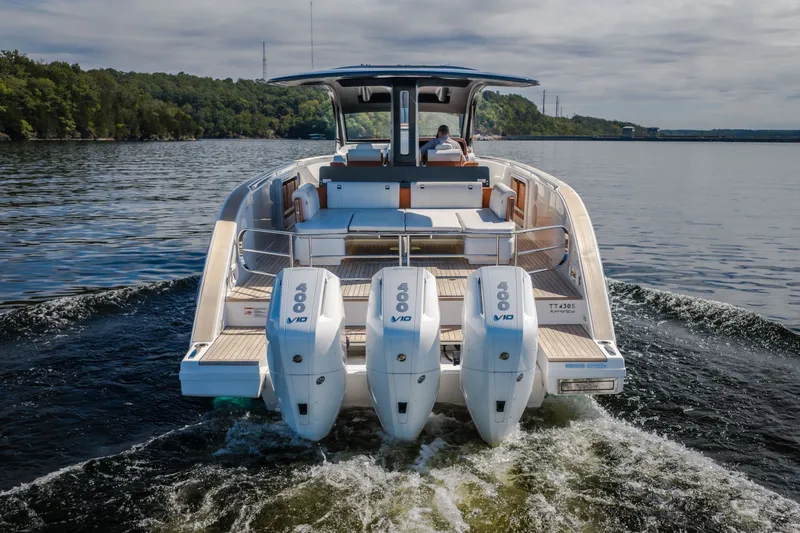 Slide: The Image of Invictus TT430 2025 luxury yacht cruising on a serene lake with triple engines. - 15