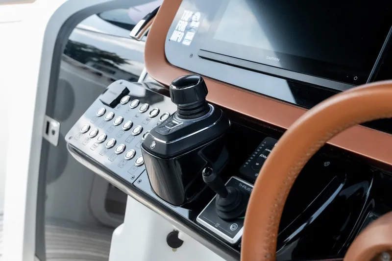 Slide: The Image of Control panel of 2025 Invictus TT430 yacht with joystick and touchscreen display. - 38