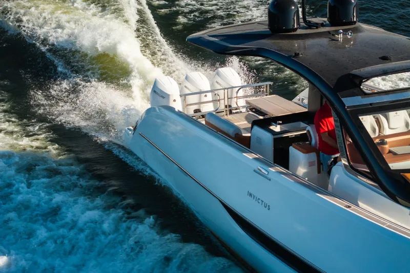 Slide: The Image of 2025 Invictus TT430 yacht cruising on water, showcasing sleek design and powerful engines. - 5