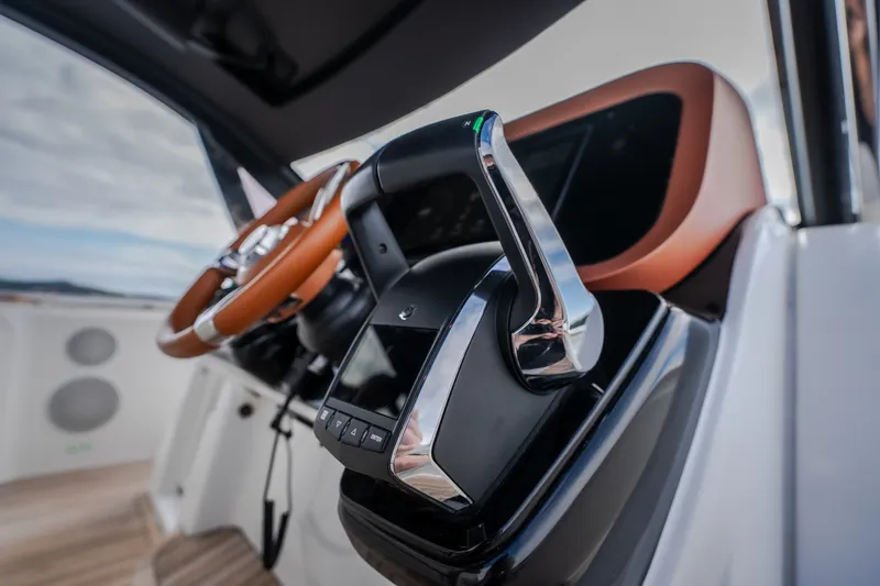 Slide: The Image of Cockpit of 2025 Invictus TT430 yacht with modern steering and controls. - 56