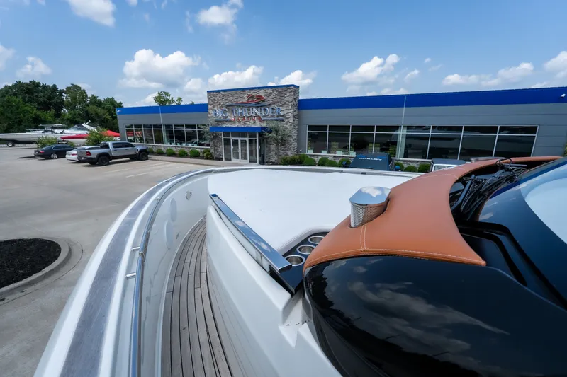 Slide: The Image of 2025 Invictus TT430 yacht at Big Thunder Marine dealership under a clear blue sky. - 42