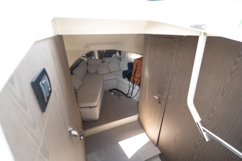 Slide: The Image of Interior of 2025 Invictus TT430 yacht, featuring modern seating and wooden finishes. - 32
