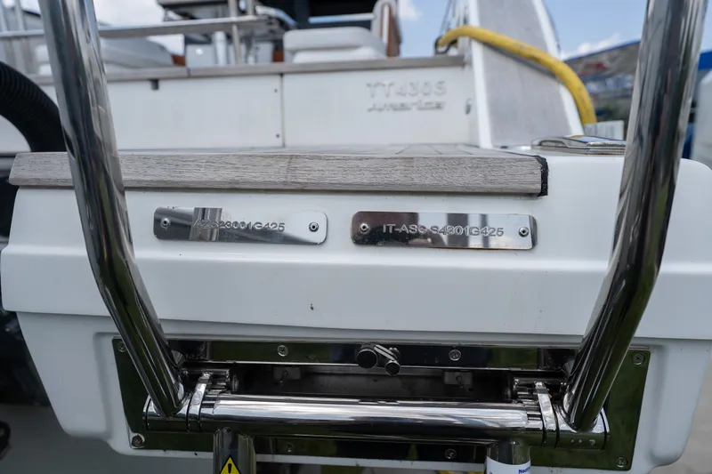 Slide: The Image of Rear view of 2025 Invictus TT430 yacht with metal details and identification plates. - 8