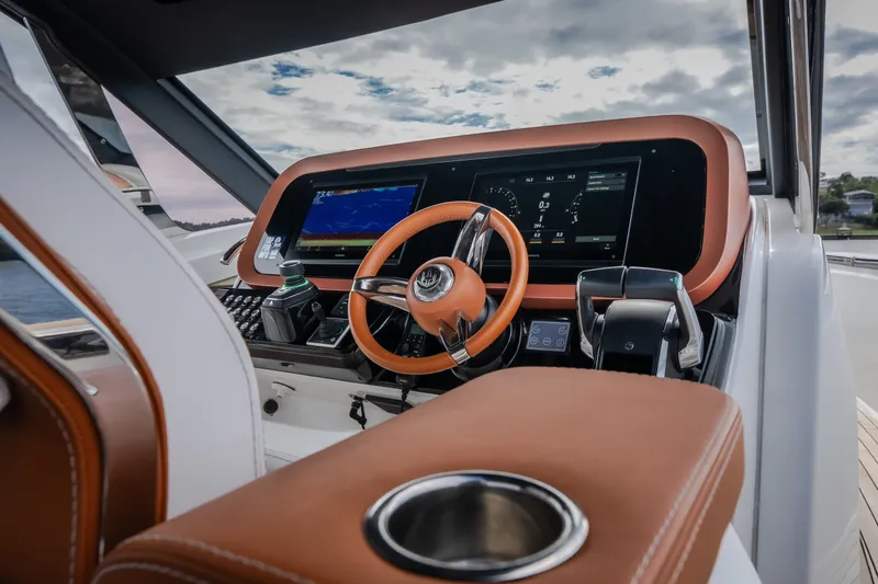 Slide: The Image of Luxurious helm of 2025 Invictus TT430 yacht with modern controls and leather accents. - 65