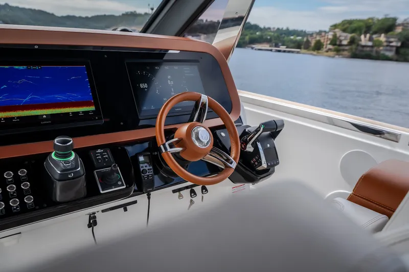Slide: The Image of Cockpit of 2025 Invictus TT430 yacht with advanced navigation displays and controls. - 67