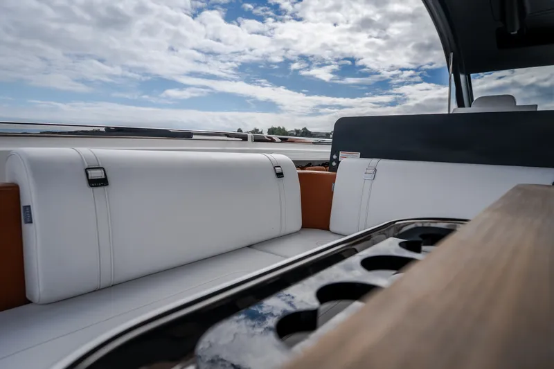 Slide: The Image of Luxurious seating on 2025 Invictus TT430 yacht under a partly cloudy sky. - 30